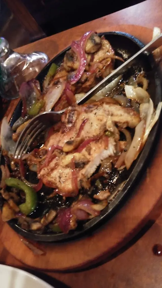 Grilled Pork Chop with Sauteed Onions and Peppers